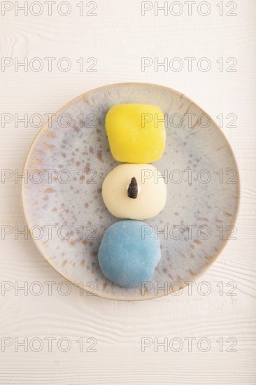 Japanese Mochi Cakes on white wooden background, top view, flat lay, copy space