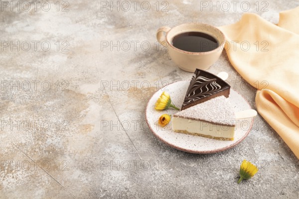 Chocolate and Vanilla Cake pops Marshmallow with cup of coffee on brown concrete background and orange linen textile. side view, copy space