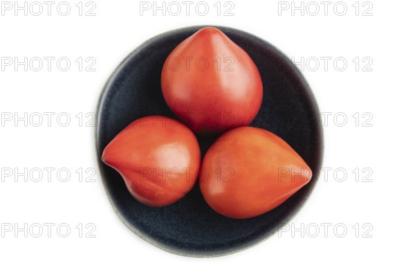 Red Heart shape tomatoes in blue bowl isolated on white background. Top view, copy space, flat lay. healthy food, vegetable, minimalism