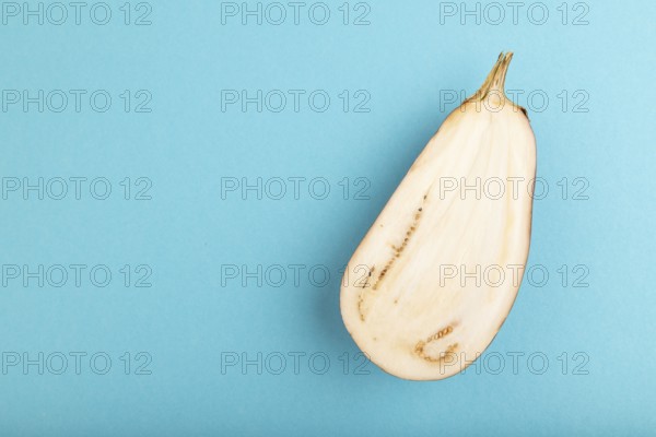 Purple Cutted eggplant on blue pastel background. Top view, flat lay, copy space. Tropical, healthy food, vegetable, slice, minimalism