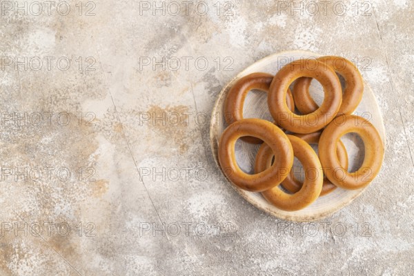 Homemade Ring Bagel on brown concrete background. top view, flat lay, copy space