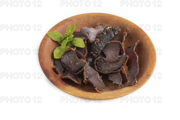 Armenian Basturma dried meat on wooden bowl isolated on white background. Side view
