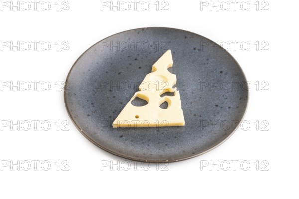 Piece of cheese with holes on blue plate isolated on white background, side view, copy space, minimalism