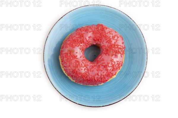 Pink Donut with sprinkles on blue ceramic plate isolated on white background, top view, flat lay, close up, minimalism