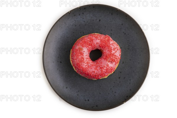 Pink Donut with sprinkles on blue ceramic plate isolated on white background, top view, flat lay, close up, minimalism