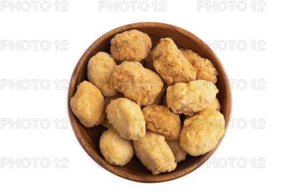 Fried crispy Chicken Nuggets in brown wooden bowl isolated on white background. top view, flat lay, copy space
