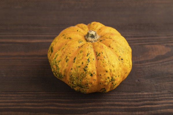 Orange Pumpkin on brown wooden background. Side view, copy space. healthy food, vegetable, minimalism