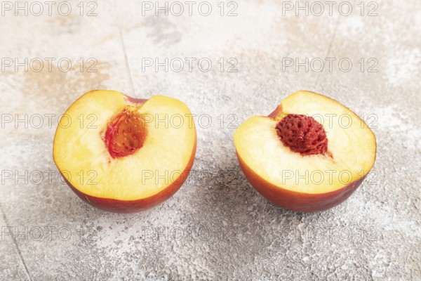 Peach Cut in half on brown concrete background. Side view, close up. healthy food, vegetable, minimalism