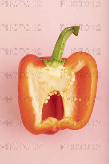 Red Cutted pepper on pink pastel background. Top view, flat lay, copy space. Tropical, healthy food, vegetable, slice, minimalism