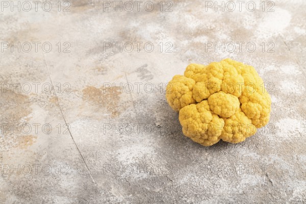 Yellow Cauliflower on brown concrete background. Side view, copy space. healthy food, vegetable, minimalism