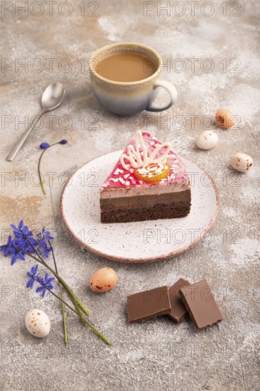Chocolate cake on brown concrete background, cup of coffee, side view, close up