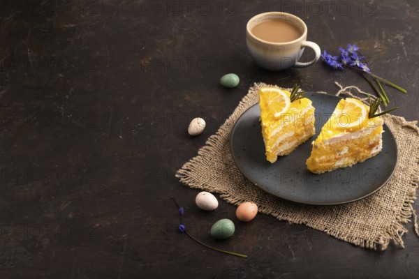 Lemon cake on black concrete background and linen textile, cup of coffee, side view, Copy space