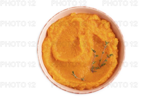 Sweet potato porridge in ceramic bowl isolated on white background. Diet, healthy eating concept. top view, flat lay, close up