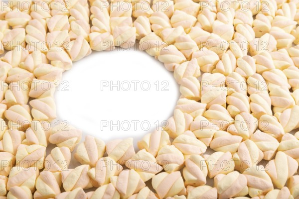 Round copy space on Orange and pink marshmallow background, side view, minimalism