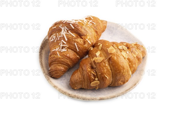 Croissant on blue plate isolated on white background, side view, close up