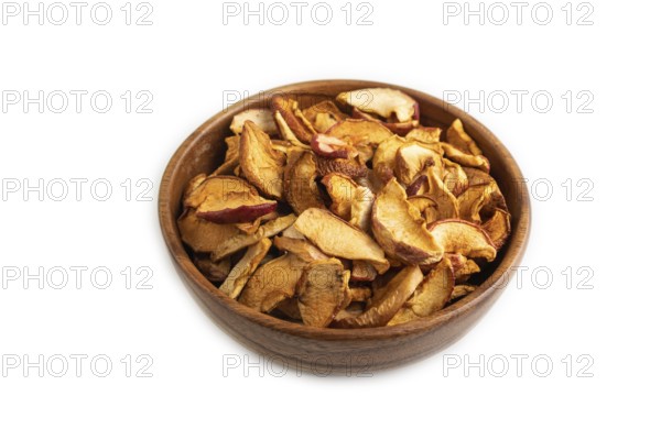 Dried Apples in wooden bowl isolated on white background. Side view, close up, healthy food, minimalism. sweet