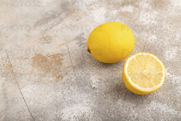 Yellow Lemon Cut in half on brown concrete background. Side view, copy space. healthy food, vegetable, minimalism. citrus