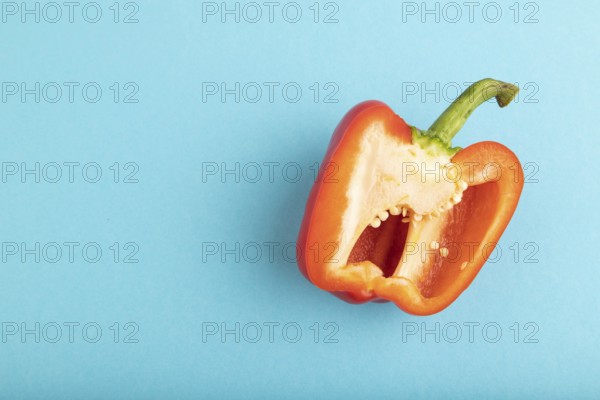 Red Cutted pepper on blue pastel background. Top view, flat lay, copy space. Tropical, healthy food, vegetable, slice, minimalism