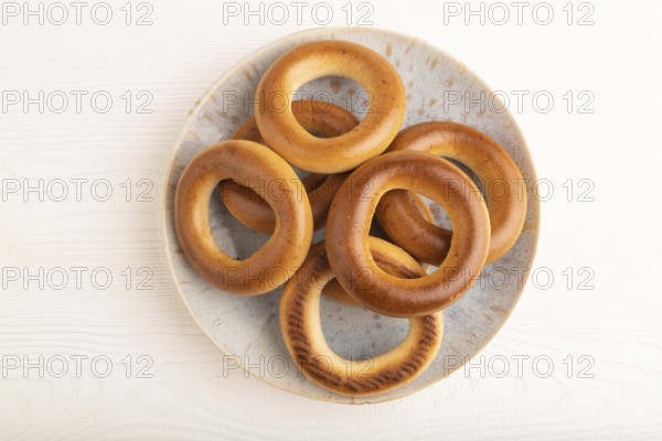 Homemade Ring Bagel on white wooden background. top view, flat lay, copy space