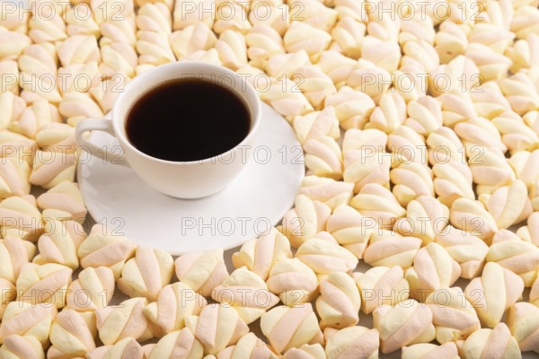 Cup of coffee on Orange and pink marshmallow background, side view, copy space, minimalism