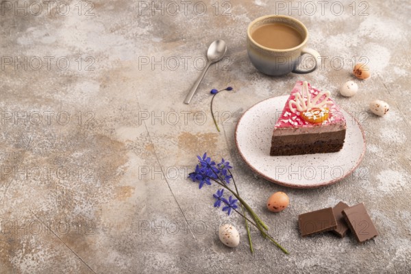 Chocolate cake on brown concrete background, cup of coffee, side view, copy space