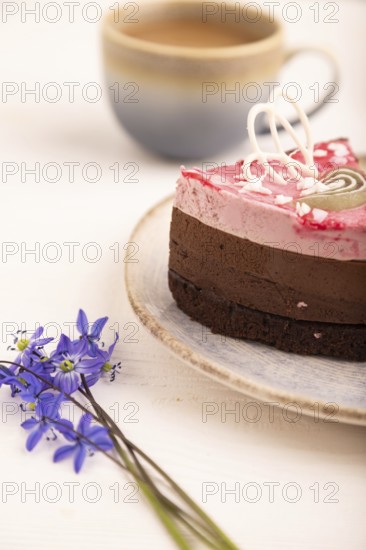 Chocolate cake on white wooden background and orange linen textile, cup of coffee, side view, close up, selective focus