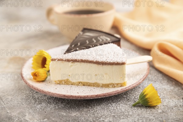 Chocolate and Vanilla Cake pops Marshmallow with cup of coffee on brown concrete background and orange linen textile. side view, close up, selective focus