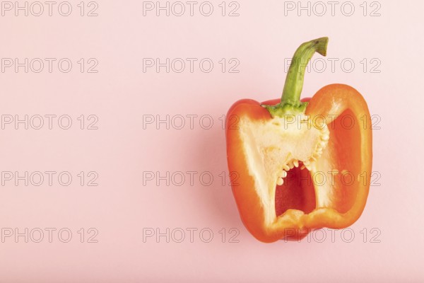 Red Cutted pepper on pink pastel background. Top view, flat lay, copy space. Tropical, healthy food, vegetable, slice, minimalism