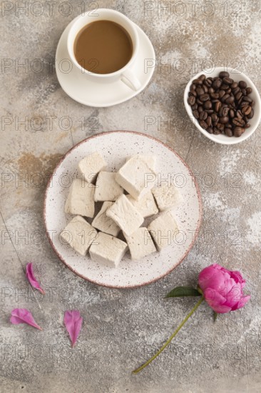 Coffee marshmallow with cup of coffee on brown concrete background. top view, flat lay, close up