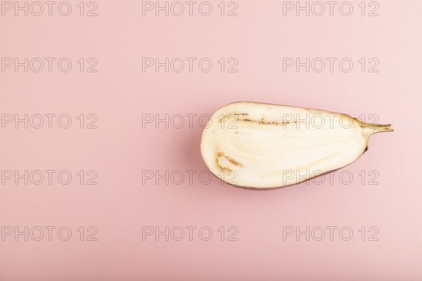 Purple Cutted eggplant with white stripes on pink pastel background. Top view, flat lay, copy space. Tropical, healthy food, vegetable, slice, minimalism