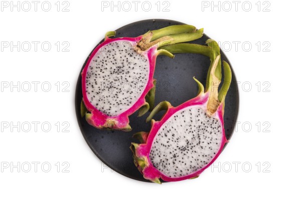 Ripe Pitaya on blue plate isolated on white background, top view, flat lay, close up, minimalism