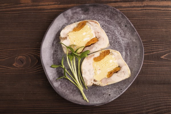 Chicken, egg and dried apricot meatloaf, microgreen on brown wooden. Diet, healthy eating. top view, close up