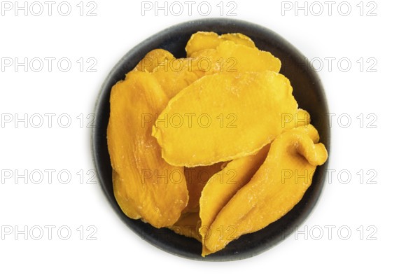 Dried Mango in blue ceramic bowl isolated on white background. Top view, close up, flat lay. healthy food, minimalism