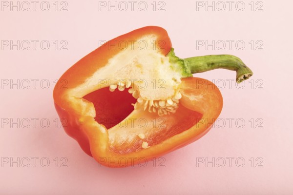 Red Cutted pepper on pink pastel background. Side view, copy space. Tropical, healthy food, vegetable, slice, minimalism