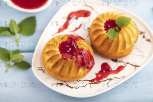 Semolina cheesecake with strawberry jam, lavender, cup of coffee on blue wooden background. side view, close up, selective focus