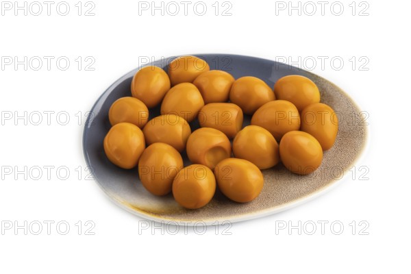 Pile of Smoked Quail eggs isolated on white background. side view, close up