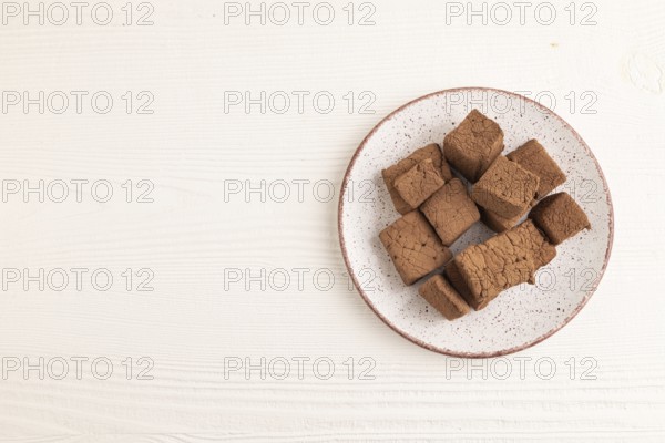 Chocolate marshmallow on white wooden background. top view, flat lay, copy space