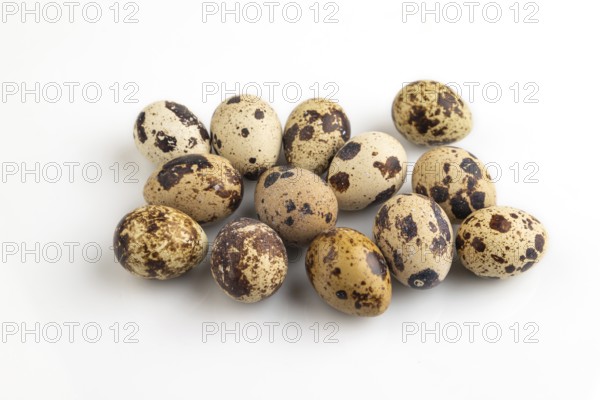 Pile of Raw Quail eggs isolated on white background. side view, close up
