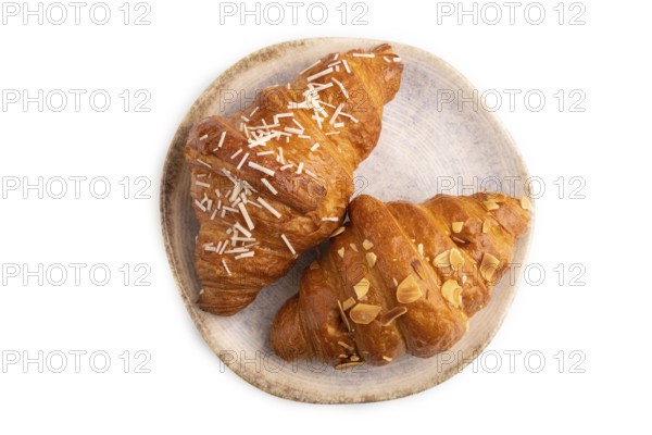 Croissant on blue plate isolated on white background, top view, flat lay, close up
