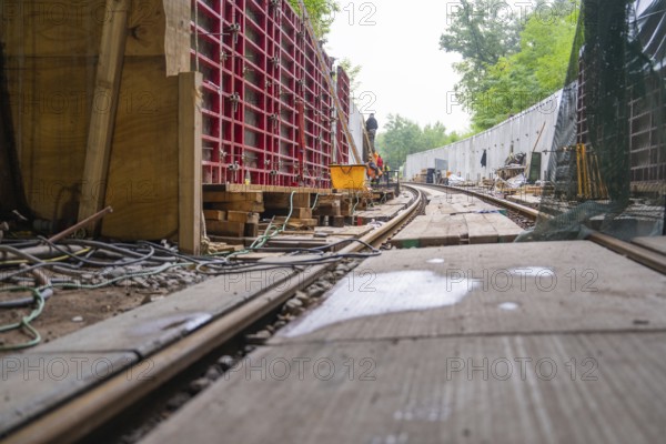 Baustelle mit Schienen und Holzbrettern in einem Waldgebiet, von Kabeln und Konstruktionsmaterial umgeben, Bau der Hermann Hessenahn, Calw, Schwarzwald, Deutschland