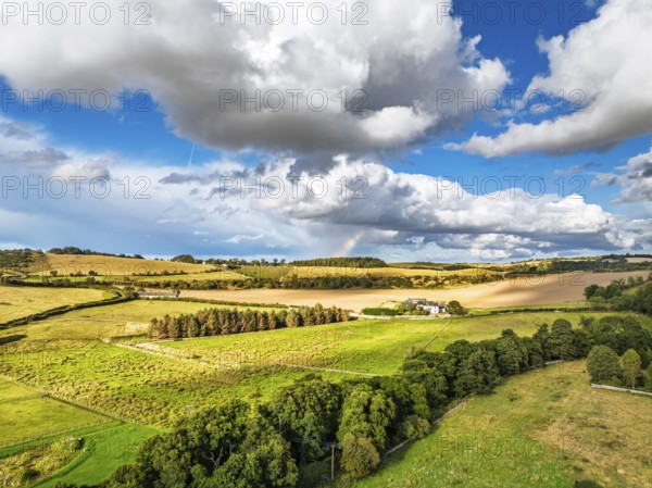 Fields and farms over Borthwick Castle from a drone, Midlothian, Scotland, UK