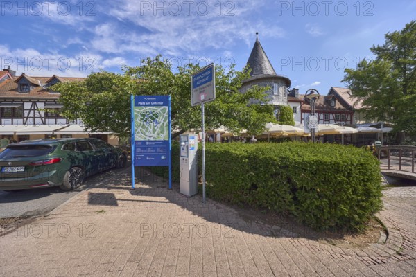 Platz, Parkplatz, Auto, Fachwerkhäuser, Turm, Bäume, Hecke, blauer Himmel, Cumuluswolken, Cirrostratuswolken, Platz am Untertor, Burggrabenstraße, Hofheim am Taunus, Main-Taunus-Kreis, Hessen, Deutschland