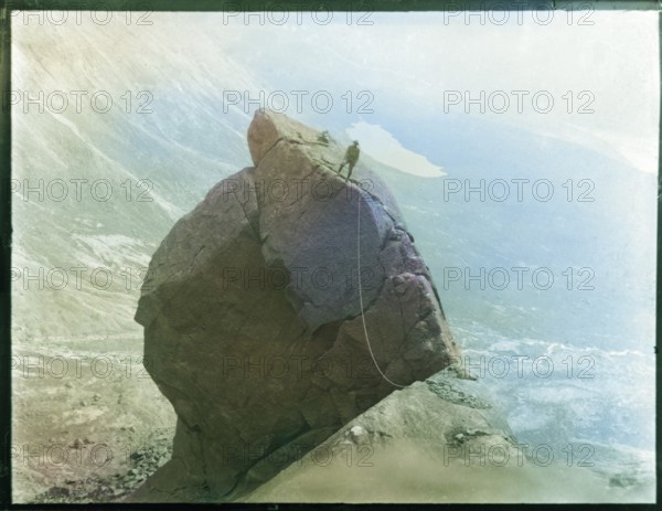Climber with rope climbing The Cioch, The Cuillins, Isle of Skye, Scotland, UK c 1910-1920 colourised image