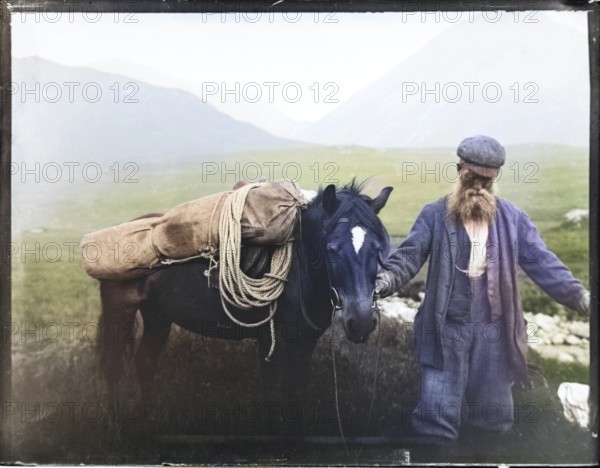 Colourised image of old man with pack horse carrying mountaineering equipment, thought to be Cuillin mountains, Skye, Scotland, UK c 1900-1920