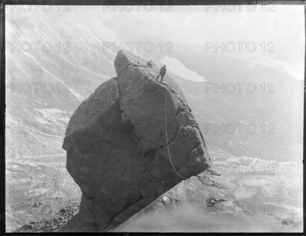 Climber with rope climbing The Cioch, The Cuillins, Isle of Skye, Scotland, UK c 1910-1920