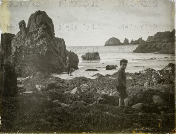 Magic lantern slide two boys playing on rocky beach circa 1900 location not known, presumed to be England, UK perhaps Cornwall