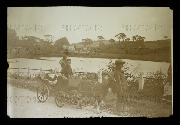 Magic lantern slide c 1900-1910 of children with a cart pulled along by a goat