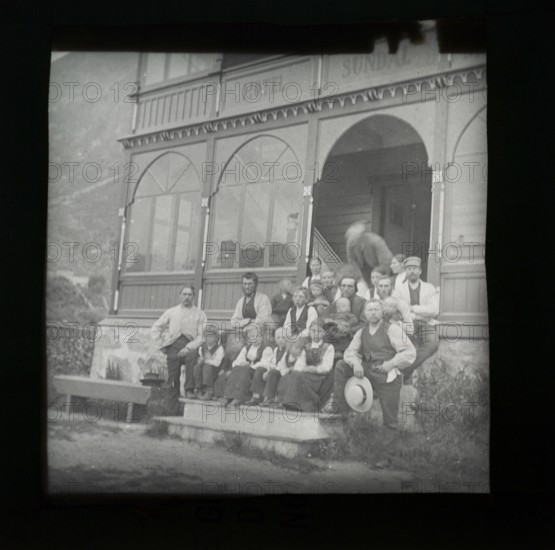 Magic lanterns slide group portrait of children and adults sitting on steps of Hotel Sundal, Sunndalsvegen, Mauranger, Hardanger, Norway, c 1900 now the Hardanger Fjord Lodge