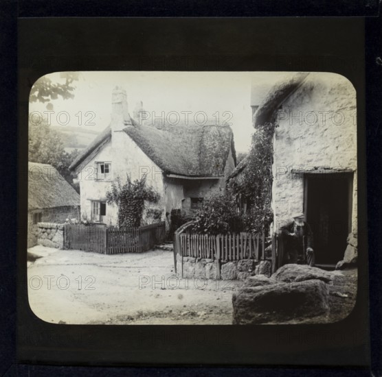 Magic lantern slide of white thatched village cottages in rural location possibly Wessex, England, UK circa 1900