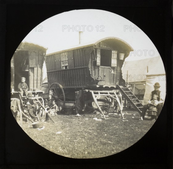 Magic lantern slide portrait of fairground travelling gypsies and caravans, UK circa 1900